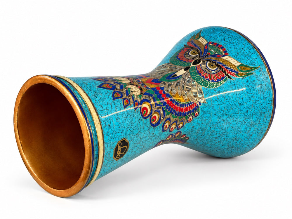 Sala Azure Owl Sombaty darbuka on its side, showing the open base and a colorful owl motif on turquoise mosaic with deep-blue borders.