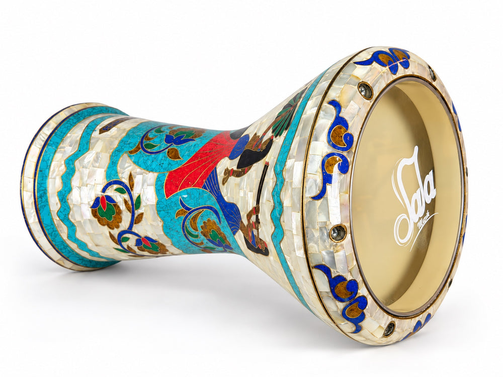 Sala Nile Muse Sombaty darbuka on its side, showing the Sala-branded drumhead and Egyptian-inspired figures, turquoise borders and colorful floral scrolls.